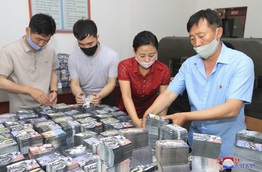 FILE - This file photo provided on June 20, 2020, by the North Korean government shows North Koreans prepare anti-South Korea propaganda leaflets in North Korea. South Korea on Monday, June 22, 2020 u ...