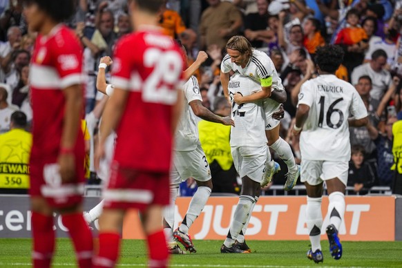 Real Madrid&#039;s Antonio Rudiger, center, celebrates with teammates after scoring his side&#039;s second goal during the Champions League opening phase soccer match between Real Madrid and VfB Stutt ...