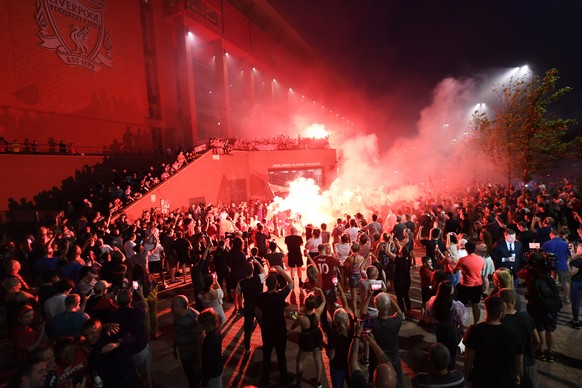 epa08509697 Ecstatic Liverpool FC celebrate outside Anfield stadium in Liverpool, Britain, 25 June 2020. Liverpool have been crowned champions of the Premier League for the first time in three decades ...