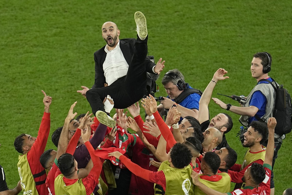 Morocco's head coach Walid Regragui is thrown in the air at the end of the World Cup round of 16 soccer match between Morocco and Spain, at the Education City Stadium in Al Rayyan, Qatar, Tuesday ...