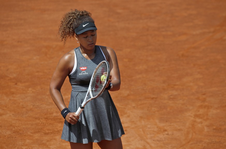 Naomi Osaka of Japan reacts after losing a point against Jessica Pegula of the United States during their match at the Italian Open tennis tournament, in Rome, Wednesday, May 12, 2021. Osaka lost agai ...