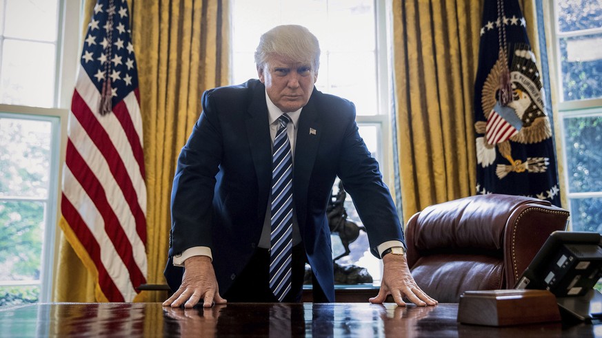 FILE - In this April 21, 2017, file photo, President Donald Trump poses for a portrait in the Oval Office in Washington after an interview with The Associated Press. Trump has proven himself an unconv ...