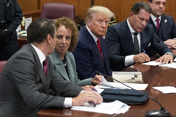 Former President Donald Trump sits at the defense table with his legal team in a Manhattan court, Tuesday, April 4, 2023, in New York. Trump is appearing in court on charges related to falsifying busi ...