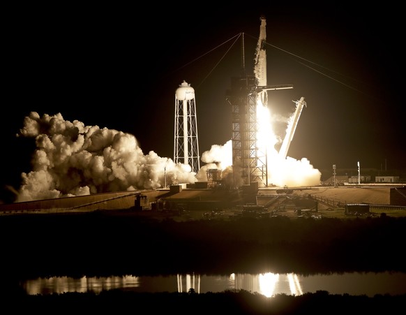 A SpaceX Falcon 9 rocket with a demo Crew Dragon spacecraft on an uncrewed test flight to the International Space Station lifts off from pad 39A at the Kennedy Space Center in Cape Canaveral, Fla., Sa ...