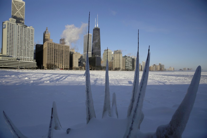 Ice forms along the shore of Lake Michigan before sunrise, Wednesday, Jan. 30, 2019, in Chicago. A deadly arctic deep freeze enveloped the Midwest with record-breaking temperatures. (AP Photo/Kiichiro ...