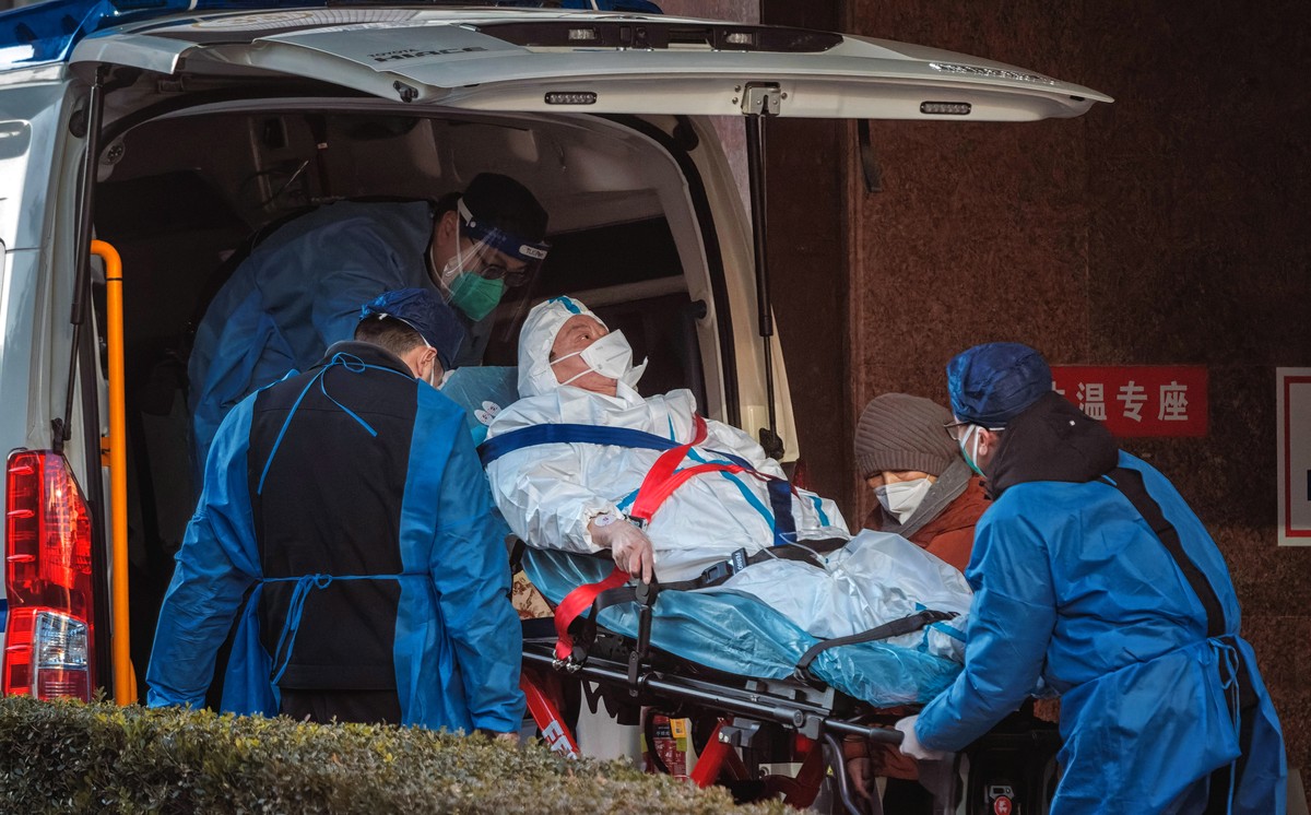 epa10376986 Health workers carry a person to the hospital, in Shanghai, China, 23 December 2022. Hospitals in China struggle to cope due to the rising number of COVID-19 cases. Since the abrupt liftin ...