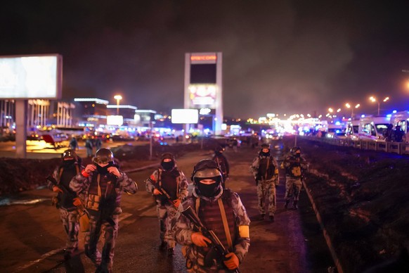 FILE - Rosguardia (Russian National Guard) servicemen secure an area at the Crocus City Hall on the western edge of Moscow, Russia, on March 23, 2024. The attack on the concert hall, the bloodiest ass ...