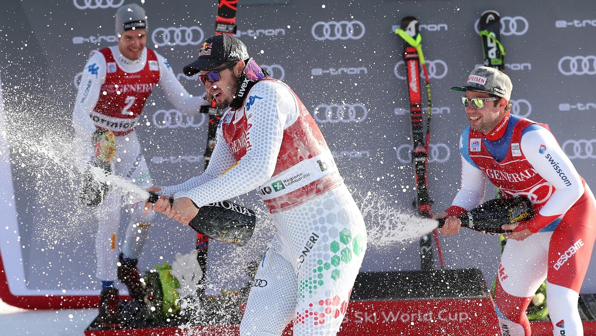 epa07251512 (L-R) Second placed Christof Innerhofer of Italy, winner Dominik Paris of Italy and third placed Beat Feuz of Switzerland celebrate on the podium after the Men's Downhill race at the  ...