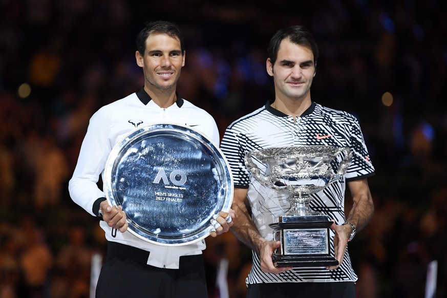 epa05759154 Roger Federer (R) of Switzerland celebrates with the trophy after winning the Men&#039;s Singles final match against Rafael Nadal (L) of Spain at the Australian Open Grand Slam tennis tour ...