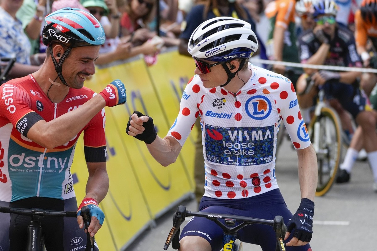 Denmark's Jonas Vingegaard, wearing the best climber's dotted jersey as the runner-up in the ranking, pump fists with Belgium's Victor Campenaerts prior to the start of the nineteenth s ...
