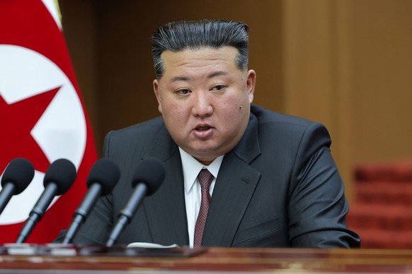 In this photo provided by the North Korean government, its leader Kim Jong Un delivers a speech during a session of the Supreme Peoples Assembly at parliament in Pyongyang, North Korea Monday, March  ...