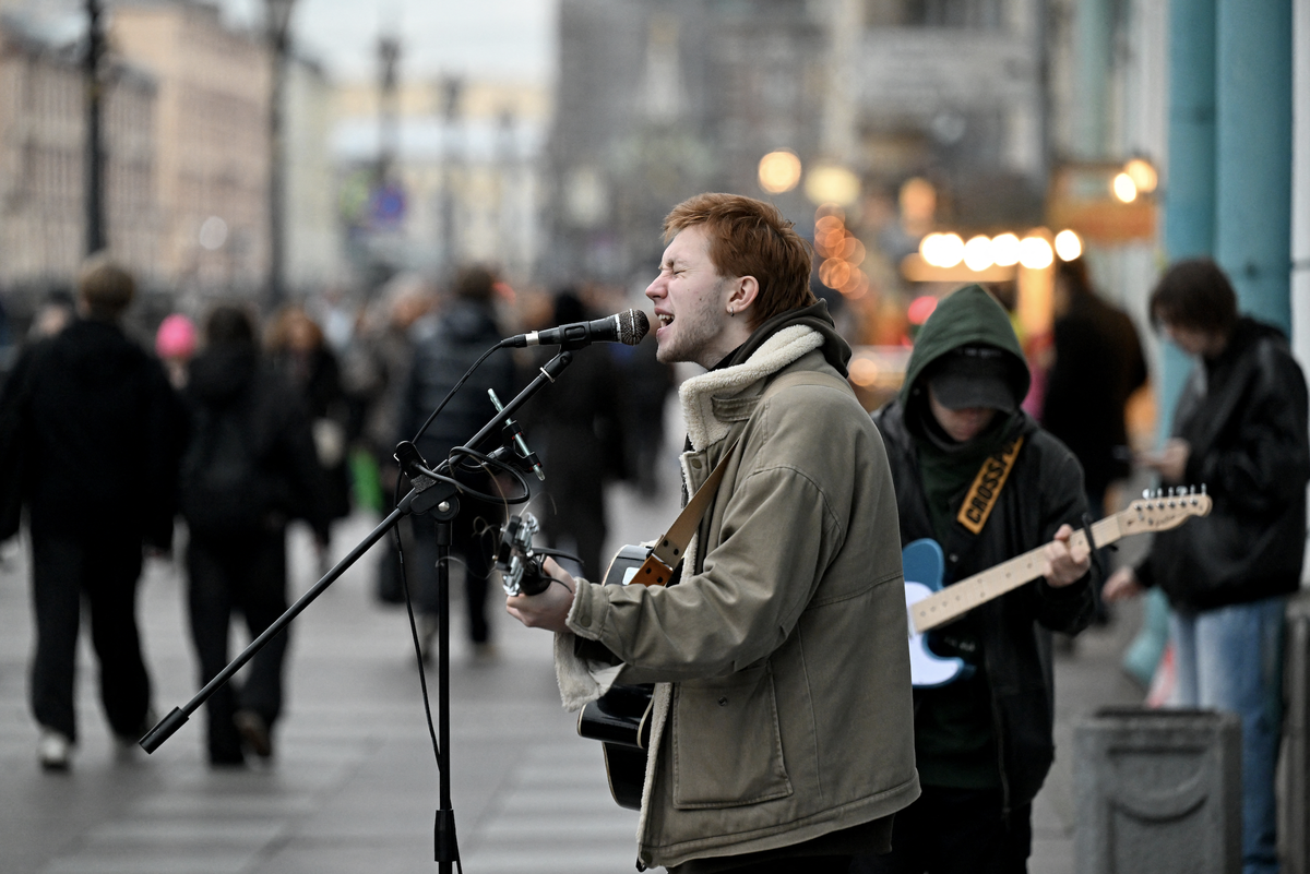Arseny, a 21-year-old street musician, performs in central Saint Petersburg on October 27, 2025.