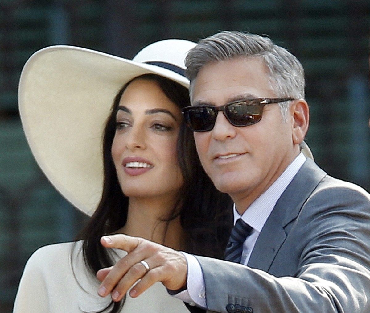George Clooney, right, flanked by his wife Amal Alamuddin, arrives at the Cavalli Palace for the civil marriage ceremony in Venice, Italy, Monday, Sept. 29, 2014. George Clooney married human rights l ...