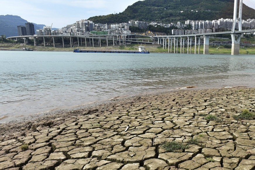 A dried riverbed is exposed after the water level dropped in the Yangtze River in Yunyang county in southwest China's Chongqing Municipality, Tuesday, Aug. 16, 2022. Unusually high temperatures a ...