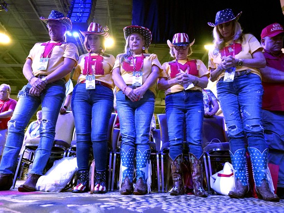 Attendees bow their heads in prayer at the Conservative Political Action Conference (CPAC) in Dallas, Thursday, Aug. 4, 2022. Hungarian Prime Minister Viktor Orban is scheduled to speak at the confere ...