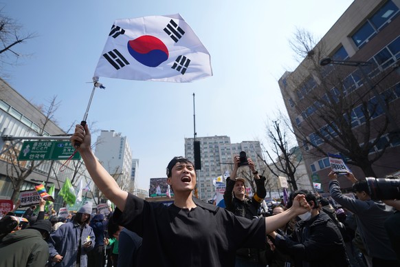 People react after hearing the news that President Yoon Suk Yeol was removed from office, in Seoul, South Korea, Friday, April 4, 2025. (AP Photo/Lee Jin-man)
South Korea Martial Law