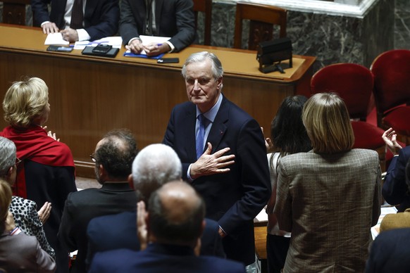 epa11757051 French Prime Minister Michel Barnier (C) gestures after delivering a speech during a no-confidence vote against his government at the National Assembly, in Paris, France, 04 December 2024. ...