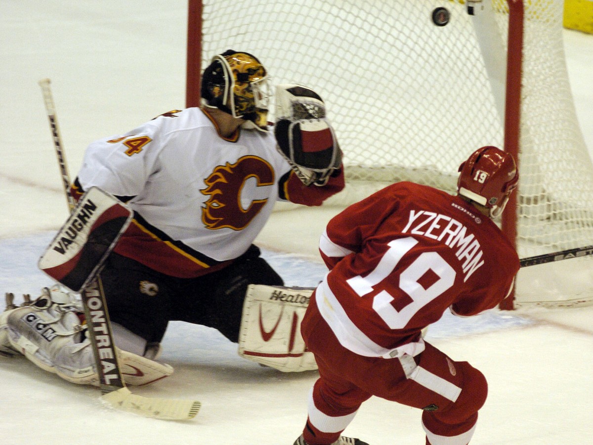 The Detroit Red Wings' Steve Yzerman scores a second-period goal on the Calgary Flames' Miikka Kiprusoff, of Finland, Saturday, April 24, 2004, during game 2 of their NHL playoff second-roun ...