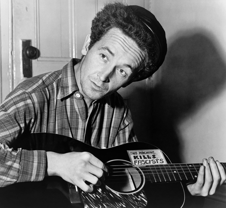 This machine KILLS FASCISTS: Woody Guthrie, 1943.
https://en.wikipedia.org/wiki/Woody_Guthrie