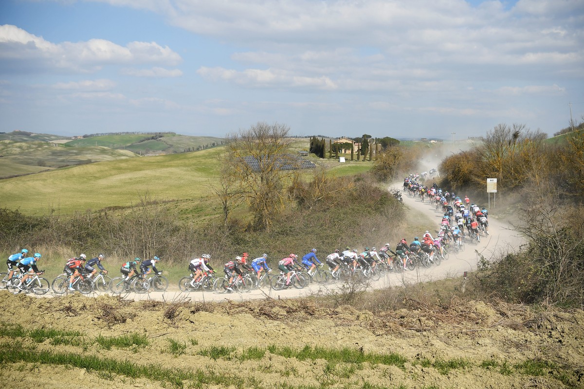 Cyclists make their way through a dusty road during the Strade Bianche (White Roads) cycling race in Siena, Italy, Saturday, March 5, 2022. (Fabio Ferrari/LaPresse via AP)