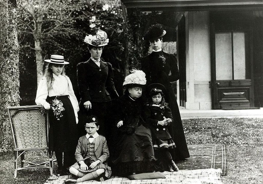 Queen Victoria (Mitte, sitzend) mit fünf ihrer insgesamt neun Kinder: (stehend, von links nach rechts) Prinzessin Victoria Eugénie von Battenberg, Prinzessin Victoria von Schleswig-Holstein, Grossherz ...