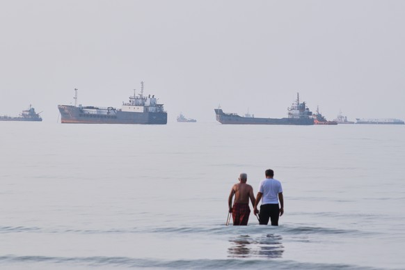 Two men wade in the waters of the Strait of Hormuz with vessels anchored in the background, off Bandar Abbas, Iran, Sunday, July 12, 2026. (Razieh Poudat/ISNA via AP)
Iran War Strait of Hormuz