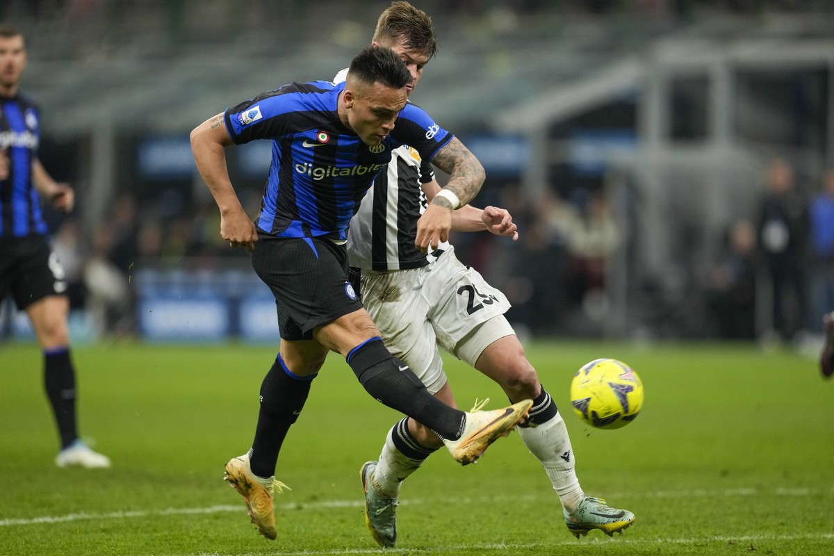 Inter Milan's Lautaro Martinez, left, scores his side's third goal during the Serie A soccer match between Inter Milan and Udinese at the San Siro stadium, in Milan, Italy, Saturday, Feb. 18 ...