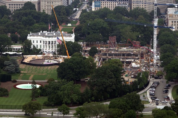 Construction on a helipad on the South Lawn and the former East Wing of the White House is seen from the Washington Monument, Friday, July 10, 2026, in Washington. (AP Photo/Mark Schiefelbein)
White H ...