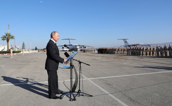 epa06382857 Russian President Vladimir Putin (L) visits the Hmeimim (also Khmeimim) Air Base, south-east of the city of Latakia in Syria, 11 December 2017. Media reports state Russian President Vladim ...