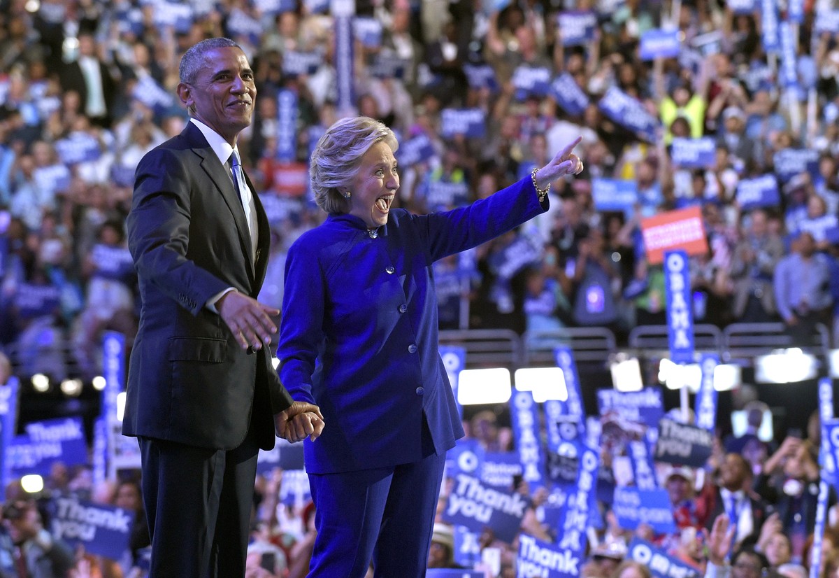 President Barack Obama stands with Democratic presidential candidate Hillary Clinton following Obama's speech at the Democratic National Convention from the Wells Fargo Center in Philadelphia, We ...