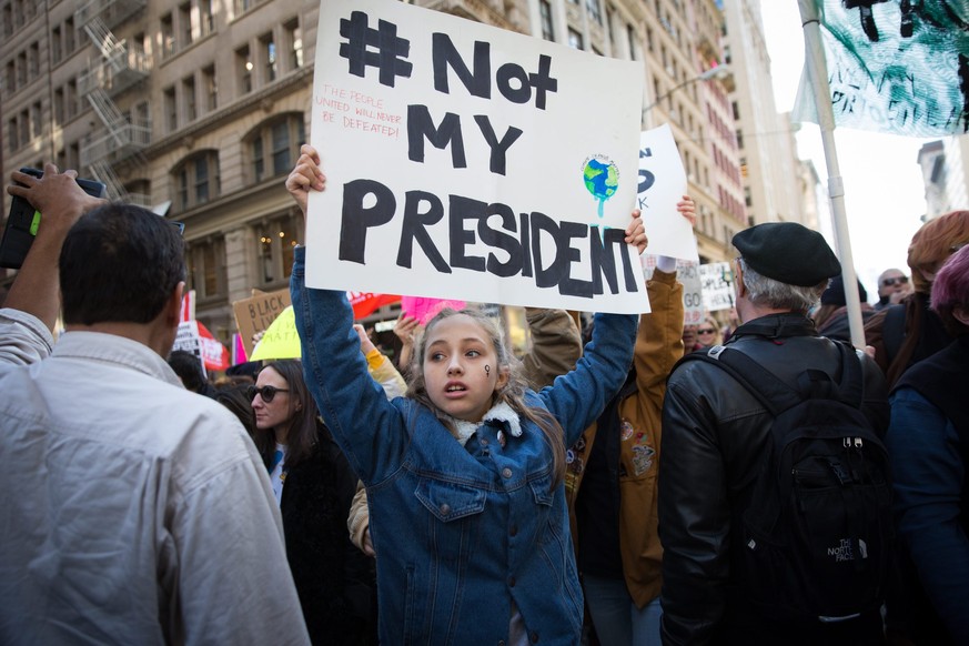 epaselect epa05628785 Thousands of protesters march up Fifth Avenue to Trump Tower to protest against President-elect Donald Trump, in Manhattan, New York, New York, USA, 12 November 2016. President-e ...