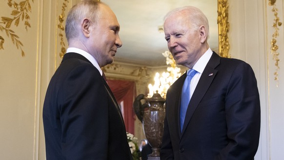 Russian president Vladimir Putin, left, talks to US president Joe Biden after their arrival at the villa La Grange, during the US - Russia summit in Geneva, Switzerland, Wednesday, June 16, 2021. (Swi ...