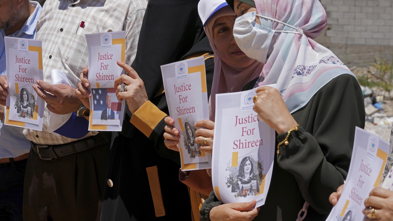 Palestinian journalists hold pictures of U.S. President Joe Biden and slain Palestinian-American journalist Shireen Abu Akleh during a sit-in protest in Gaza City, Wednesday, July 13, 2022. The protes ...