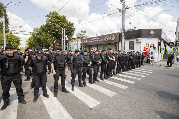 epa10698265 Moldovan riot police provide protection for people attending a rally organized by the LGBT (Lesbian, Gay, Bisexual and Transgender) community, during their march for human rights and equal ...