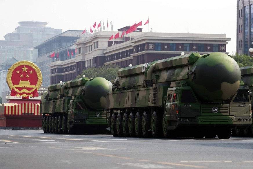 BEIJING, CHINA - OCTOBER 01: Military vehicles carrying nuclear-capable DF-41 intercontinental ballistic missiles march during a military parade marking the 70th anniversary of the founding of the Peo ...