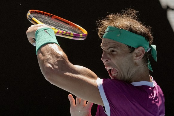 Rafael Nadal of Spain plays a forehand return to Denis Shapovalov of Canada during their quarterfinal match at the Australian Open tennis championships in Melbourne, Australia, Tuesday, Jan. 25, 2022. (AP Photo/Simon Baker)
Rafael Nadal