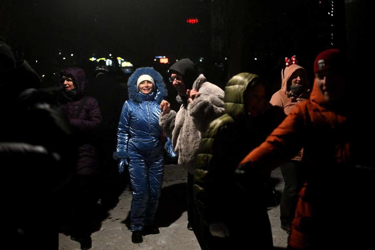 Les habitants dansent lors d'une fête en plein air pour ne plus penser aux problèmes, alors que de nombreux appartements restent sans chauffage et électricité à Kiev, le 18 janvier 2026.