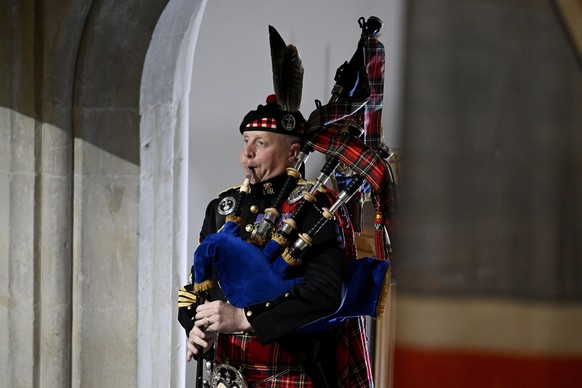 Pipe Major Paul Burns of the Royal Regiment of Scotland helps to close the State Funeral of Queen Elizabeth II with a rendition of the traditional piece Sleep, Dearie, Sleep at Westminster Abbey, in L ...