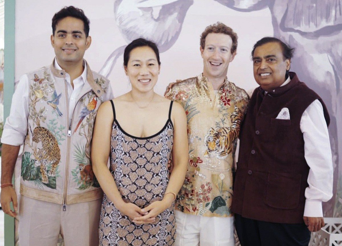 This photograph released by the Reliance group shows R to L, billionaire industrialist Mukesh Ambani, Mark Zuckerberg, Priscilla Chan, and Akash Ambani posing for a photograph at a pre-wedding bash of ...