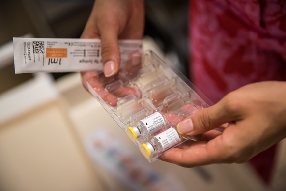 epa10101234 A health worker prepares a dose of Imvanex vaccine used to protect against Monkeypox virus in a refrigerator at the Edison municipal vaccination center in Paris, France, 01 August 2022. Mo ...