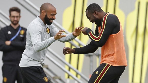 Belgium assistant coach Thierry Henry, left, jokes with Belgium&#039;s Romelu Lukaku during a training session on the eve of the semifinal against France at the 2018 soccer World Cup in Moscow, Russia ...