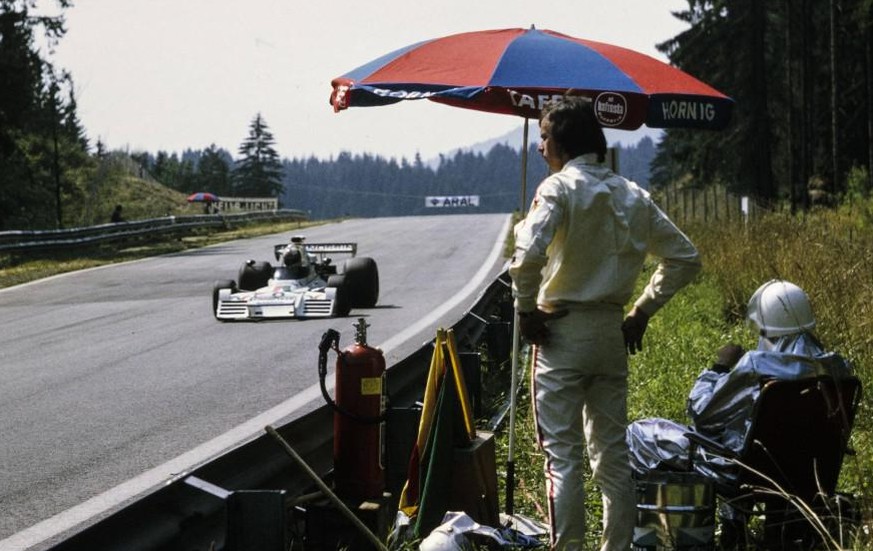 IMAGO / Motorsport Images

1973 Austrian GP RED BULL RING, AUSTRIA - AUGUST 19: Rolf Stommelen, Brabham BT42 Ford, passes Emerson Fittipaldi standing with a fire marshal on the side of the track after ...