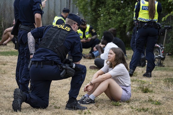 Police talk with Greta Thunberg as they move climate activists from the organization Ta Tillbaka Framtiden, who are blocking the entrance to Oljehamnen in Malmo, Sweden, on June 19, 2023, for the 5th  ...