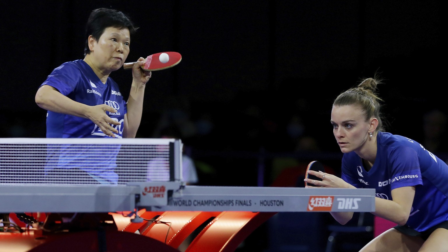 Luxembourg&#039;s Xia Lian Ni, left, serves next to Sarah De Nutte, right, during a semifinals women&#039;s doubles match during the World Table Tennis Championships, Sunday, Nov. 28, 2021, in Houston ...