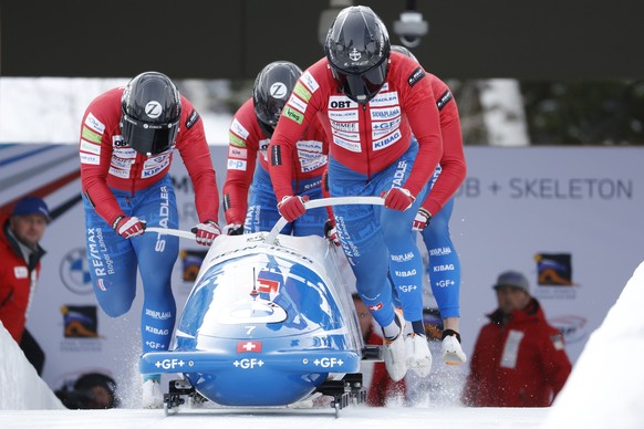 Driver Michael Vogt, front, Silvio Weber, Cyril Bierl and Sandro Michel, of Switzerland, compete in the four-man bobsled World Cup race Saturday, Dec. 3, 2022, in Park City, Utah. (AP Photo/Jeff Swing ...