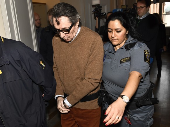 epa07160652 Frenchman Jean-Claude Arnault (C) is escorted out after the first day of his appeal trial in Stockholm, Sweden, 12 November 2018. An appeals trial opened in Stockholm on 12 November, for a ...