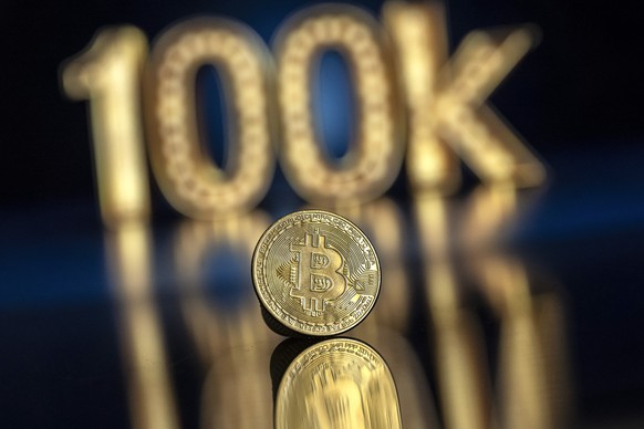 epa11734560 An illustration shows a symbolic Bitcoin in front of a 100k sign, in Lugano, Switzerland, 22 November 2024. The world&#039;s most popular cryptocurrency hit a record high on 21 November, a ...