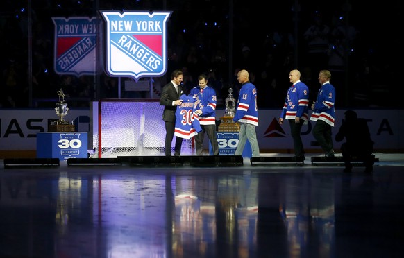 The New York Rangers retire number 30 of former goaltender Henrik Lundqvist, far left, before an NHL hockey game between the Rangers and the Minnesota Wild Friday, Jan. 28, 2022 in New York. He was jo ...