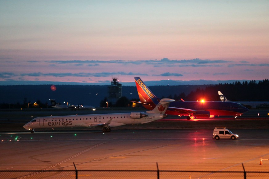 Planes sit on the tarmac at Sea-Tac International Airport after service was halted after an Alaska Airlines plane was stolen Friday, Aug. 10, 2018, in Wash. An airline mechanic stole an Alaska Airline ...