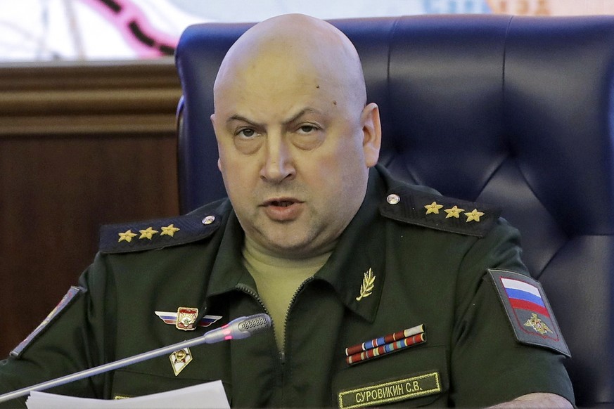 FILE - Colonel General Sergei Surovikin, commander of Russian forces in Syria, speaks, with a map of Syria projected on the screen in the back, during a briefing at the Russian Defense Ministry in Mos...